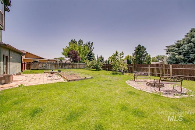 1239 Willow Creek Dr, Nampa, ID 83686 - view of yard featuring a patio area, a fire pit, a vegetable garden, and cooling unit
