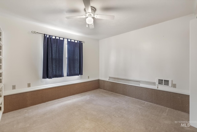 unfurnished room with carpet and ceiling fan