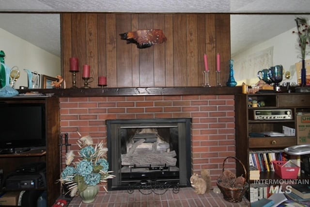 interior details featuring a fireplace and a textured ceiling