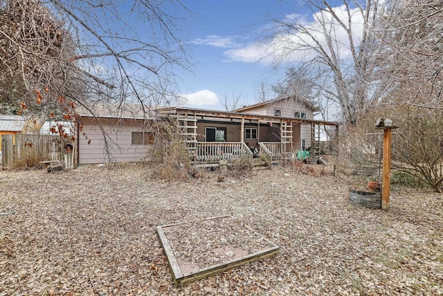 back of house featuring a porch