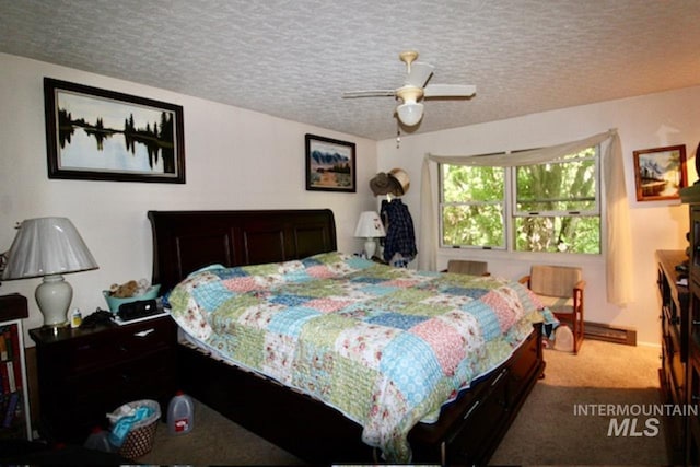 carpeted bedroom featuring ceiling fan and a textured ceiling