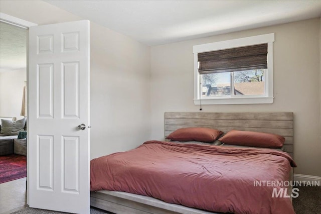 carpeted bedroom with baseboards