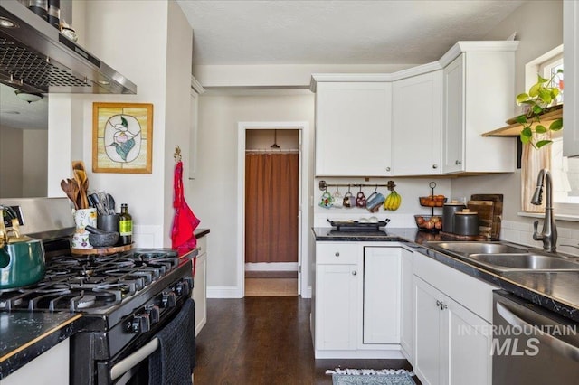 kitchen featuring black gas stove, stainless steel dishwasher, white cabinetry, a sink, and extractor fan