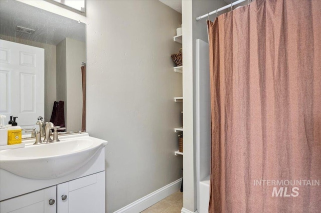 bathroom featuring baseboards, visible vents, shower / bath combination with curtain, and vanity