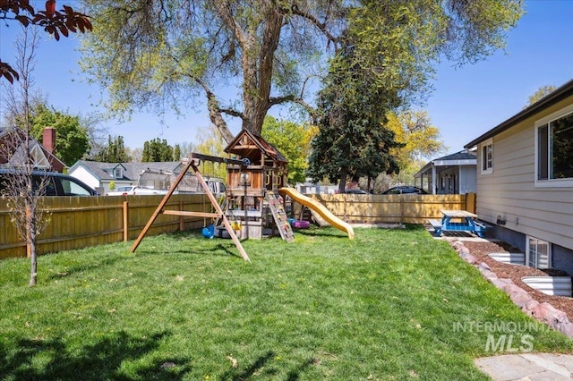 view of yard with a fenced backyard and a playground
