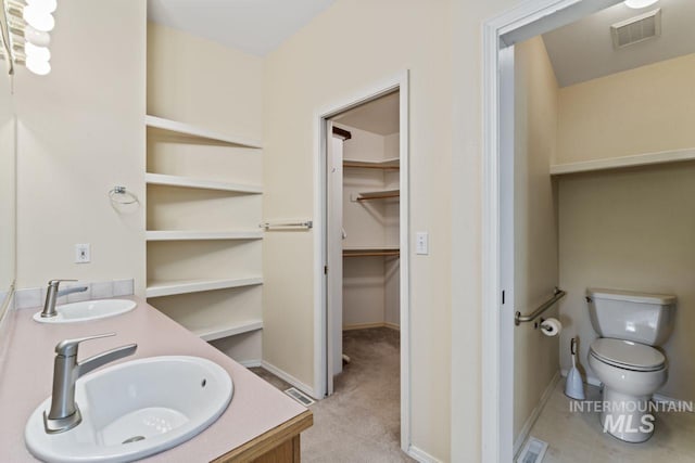 1548 N Vineyards Ave, Meridian, ID 83642 - bathroom featuring double vanity, toilet, a spacious closet, and baseboards