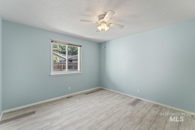 1548 N Vineyards Ave, Meridian, ID 83642 - empty room featuring wood finished floors, a textured ceiling, a ceiling fan, and baseboards