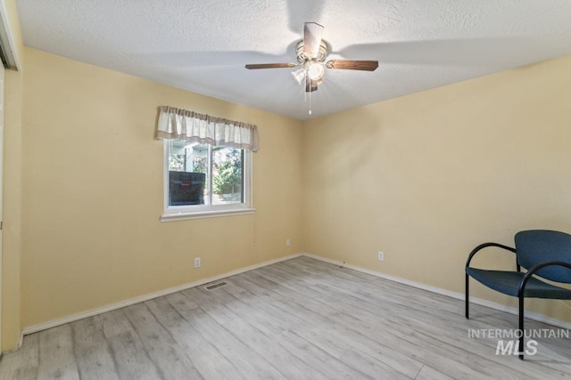 1548 N Vineyards Ave, Meridian, ID 83642 - unfurnished room featuring wood finished floors, a textured ceiling, ceiling fan, and baseboards