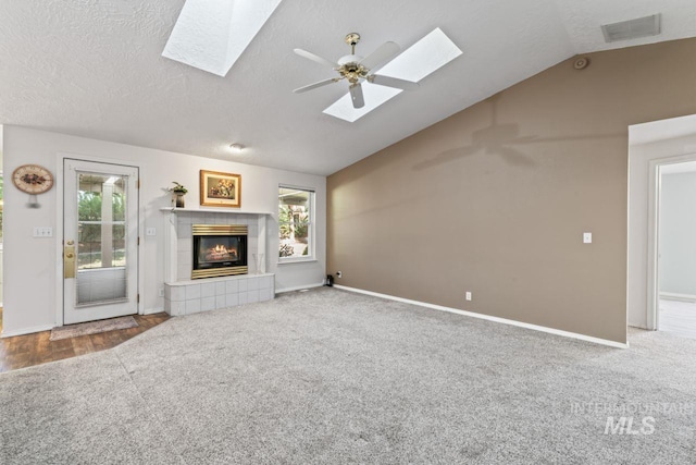 1548 N Vineyards Ave, Meridian, ID 83642 - unfurnished living room featuring a skylight, lofted ceiling, ceiling fan, a tile fireplace, and plenty of natural light