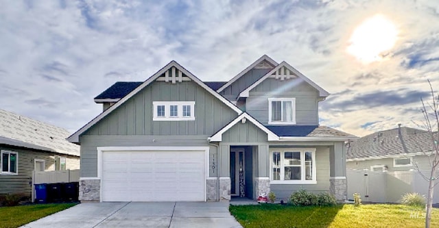 craftsman house with a garage and a front lawn