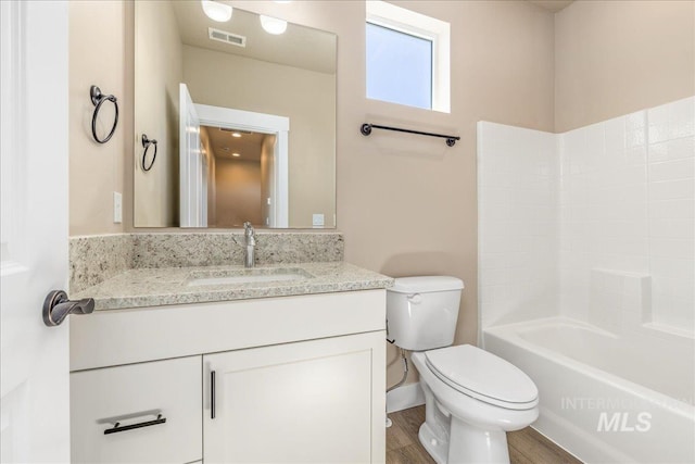 1438 N Cole Cottage Ln, Boise, ID 83704 - full bathroom featuring toilet, vanity, wood finished floors, and tub / shower combination