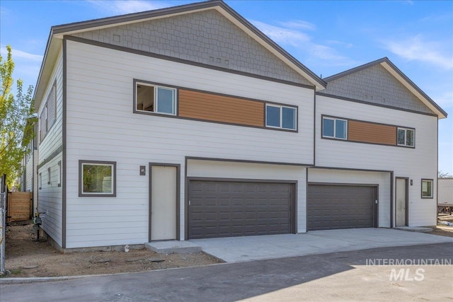 1438 N Cole Cottage Ln, Boise, ID 83704 - back of property with an attached garage and driveway