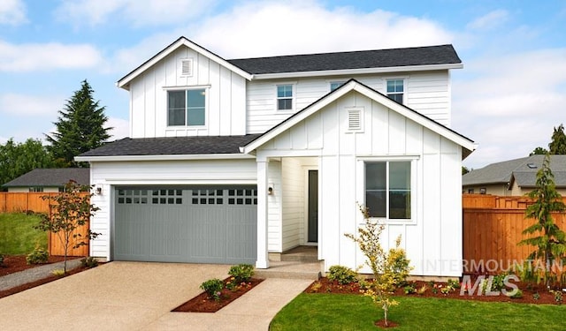 modern farmhouse with fence, board and batten siding, and concrete driveway