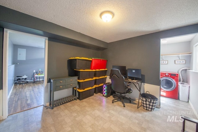 office space with baseboards, a textured ceiling, washer / clothes dryer, and tile patterned floors