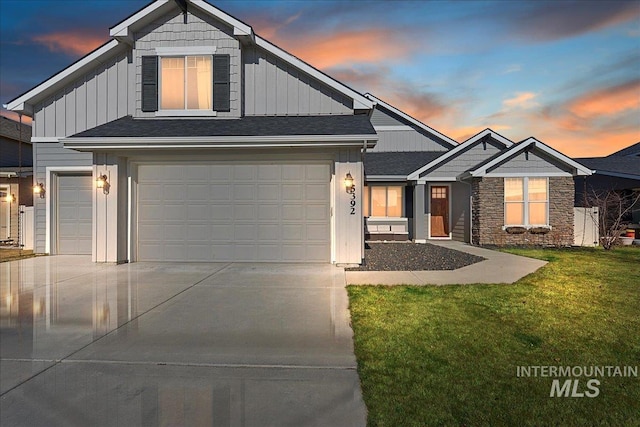 view of front of home featuring concrete driveway, a front lawn, board and batten siding, and an attached garage