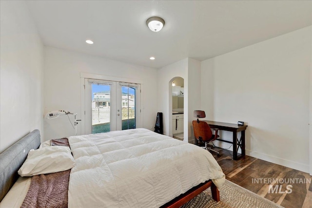 bedroom with arched walkways, french doors, dark wood-type flooring, access to outside, and baseboards