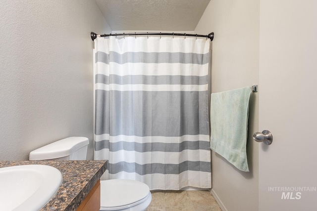 full bathroom with tile patterned floors, toilet, a textured ceiling, a shower with shower curtain, and vanity