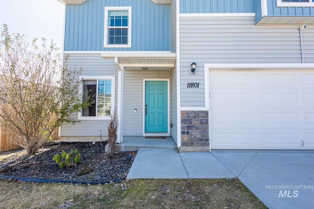 view of exterior entry with board and batten siding and stone siding