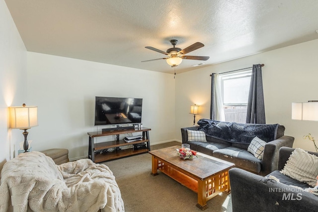 living area with carpet, baseboards, visible vents, ceiling fan, and a textured ceiling