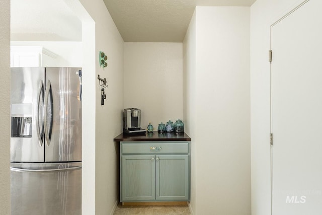 interior space featuring dark countertops and stainless steel fridge with ice dispenser