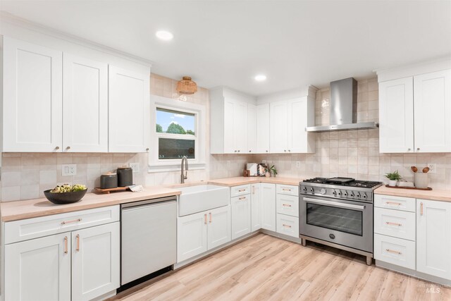 1600 E Victory Rd, Boise, ID 83706 - kitchen with wall chimney range hood, stainless steel range, dishwasher, a sink, and light countertops