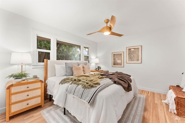 1600 E Victory Rd, Boise, ID 83706 - bedroom with light wood-type flooring, baseboards, and a ceiling fan