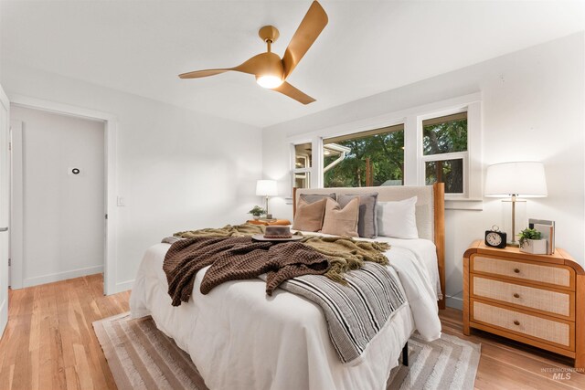 1600 E Victory Rd, Boise, ID 83706 - bedroom featuring light wood-style floors, baseboards, and a ceiling fan