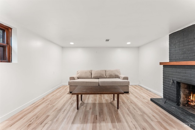 1600 E Victory Rd, Boise, ID 83706 - living area featuring a brick fireplace, light wood-style floors, recessed lighting, and baseboards