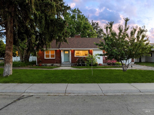 1600 E Victory Rd, Boise, ID 83706 - view of front of home featuring a front lawn, brick siding, and roof with shingles