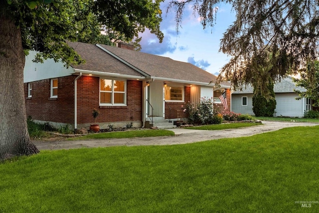 1600 E Victory Rd, Boise, ID 83706 - view of front of house featuring brick siding, a front lawn, a chimney, and a shingled roof