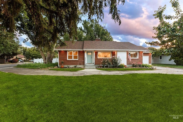 1600 E Victory Rd, Boise, ID 83706 - single story home featuring brick siding, a yard, a garage, and concrete driveway