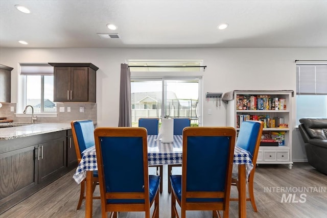 dining space featuring wood finished floors, visible vents, and recessed lighting