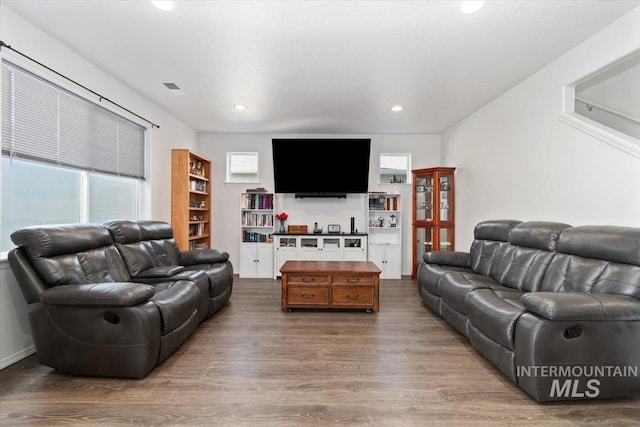 living room featuring recessed lighting, wood finished floors, and visible vents