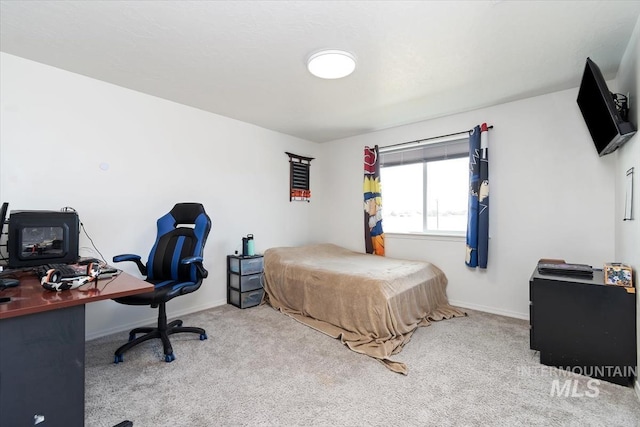 carpeted bedroom featuring baseboards