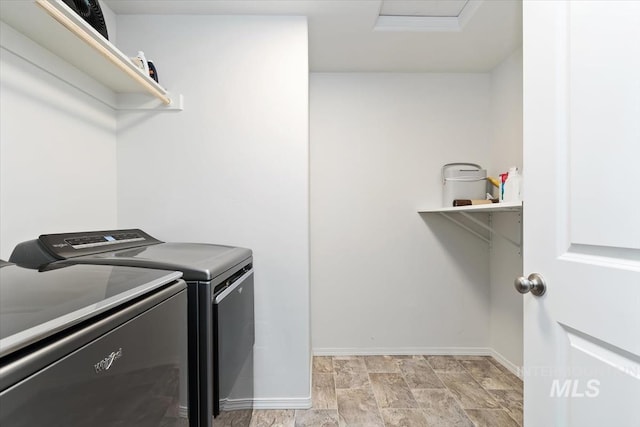laundry area featuring attic access, baseboards, independent washer and dryer, and laundry area