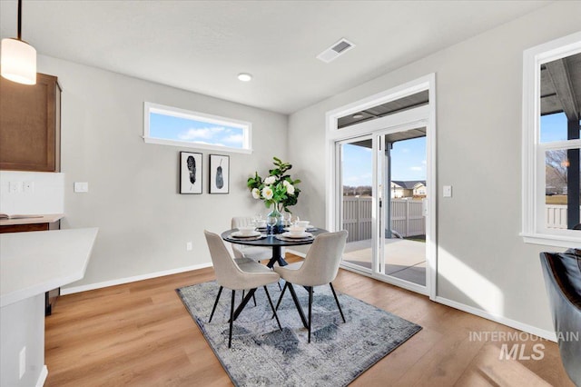 dining area with light hardwood / wood-style flooring