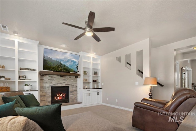 1123 Drexel Hill Ave, Caldwell, ID 83605 - carpeted living room with a ceiling fan, a fireplace, built in shelves, baseboards, and a textured ceiling