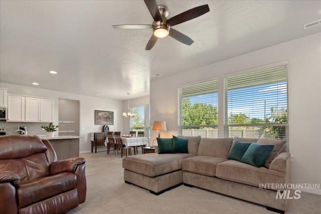 1123 Drexel Hill Ave, Caldwell, ID 83605 - living room featuring a chandelier, ceiling fan, recessed lighting, and a textured ceiling
