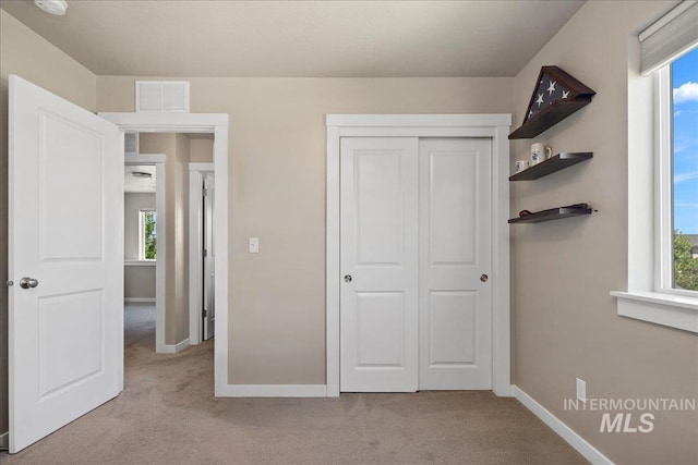 1123 Drexel Hill Ave, Caldwell, ID 83605 - unfurnished bedroom with carpet, multiple windows, baseboards, and a closet
