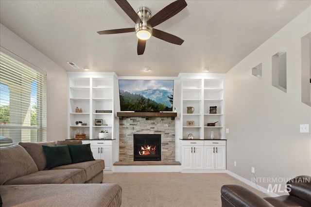 1123 Drexel Hill Ave, Caldwell, ID 83605 - living room featuring a fireplace, ceiling fan, light colored carpet, baseboards, and a textured ceiling
