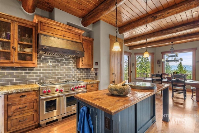 370 Blackhawk Lake Dr, Mccall, ID 83638 - kitchen with range with two ovens, wooden ceiling with exposed beams, premium range hood, wooden counters, and light wood finished floors