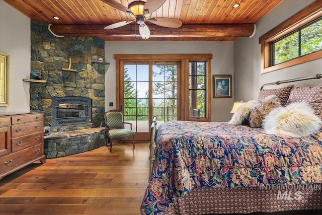 370 Blackhawk Lake Dr, Mccall, ID 83638 - bedroom featuring wood ceiling with exposed beams, access to outside, hardwood / wood-style floors, a stone fireplace, and a ceiling fan