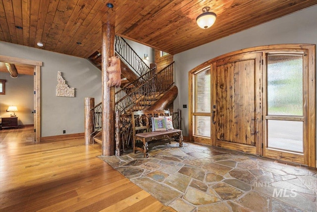 370 Blackhawk Lake Dr, Mccall, ID 83638 - foyer featuring wood ceiling, stairway, arched walkways, baseboards, and wood finished floors