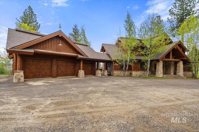 370 Blackhawk Lake Dr, Mccall, ID 83638 - log home featuring roof with shingles, an attached garage, and stone siding