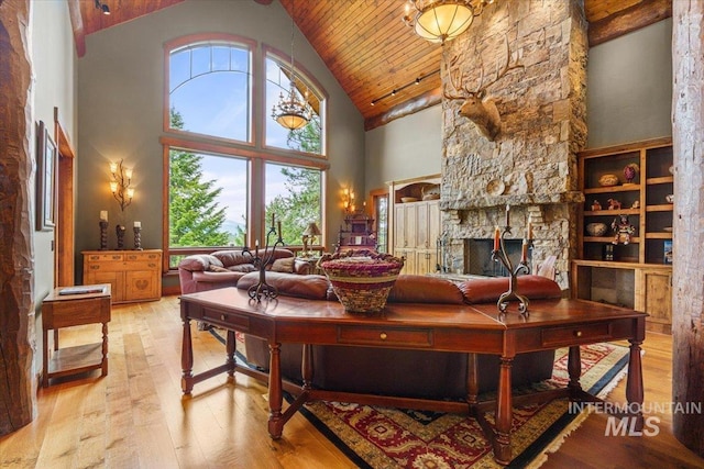 370 Blackhawk Lake Dr, Mccall, ID 83638 - living room with high vaulted ceiling, hardwood / wood-style floors, wooden ceiling, and a stone fireplace