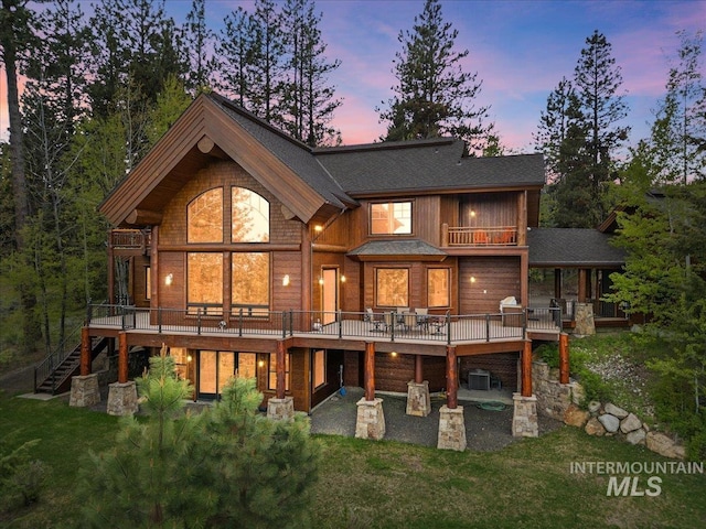 370 Blackhawk Lake Dr, Mccall, ID 83638 - rear view of house with a balcony, stairs, a lawn, and a patio