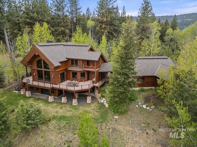 370 Blackhawk Lake Dr, Mccall, ID 83638 - rear view of property featuring a wooded view, a wooden deck, and a shingled roof
