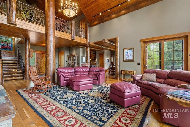 370 Blackhawk Lake Dr, Mccall, ID 83638 - living room with high vaulted ceiling, wooden ceiling, hardwood / wood-style floors, and stairway