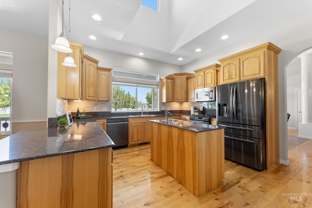 4019 E Man O War Dr, Nampa, ID 83686 - kitchen featuring stainless steel appliances, healthy amount of natural light, arched walkways, light wood-type flooring, and recessed lighting