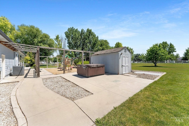 4019 E Man O War Dr, Nampa, ID 83686 - view of patio featuring a hot tub, a storage unit, and a playground